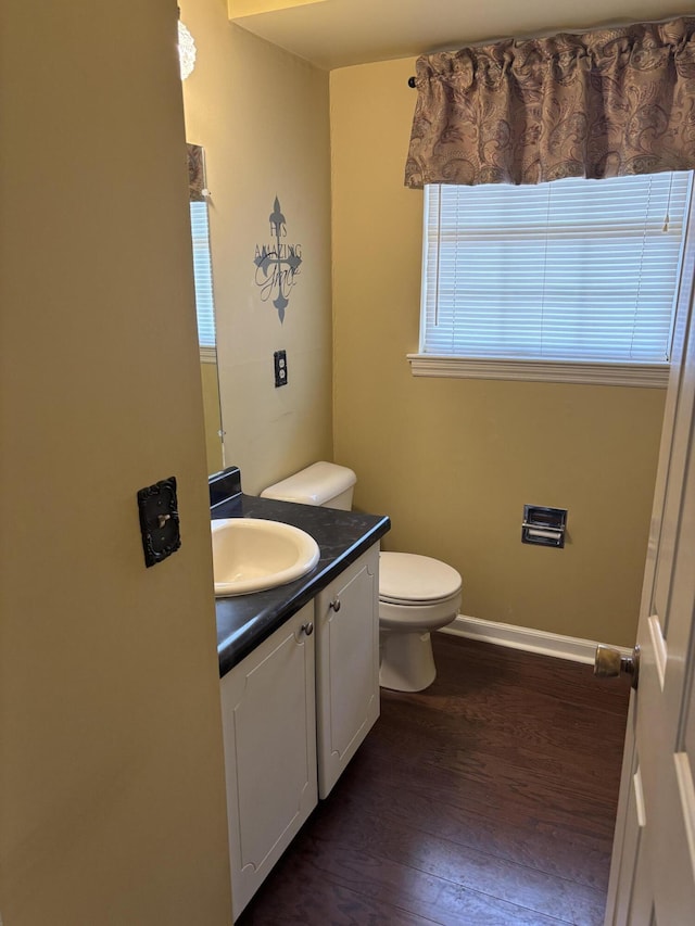 bathroom featuring hardwood / wood-style flooring, vanity, and toilet