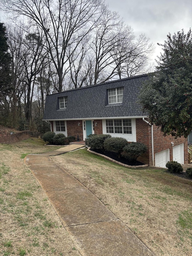 view of front of house featuring a garage and a front lawn