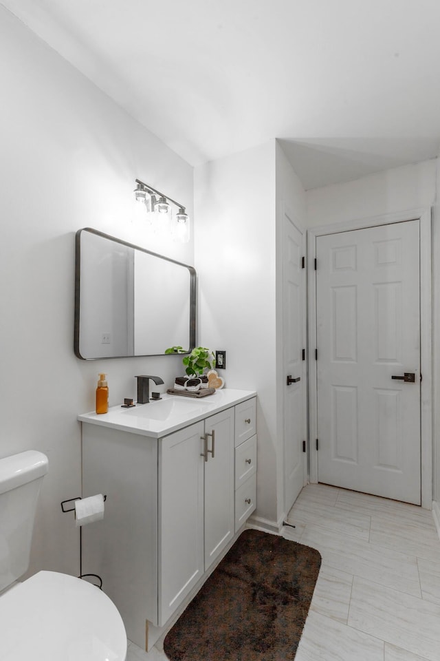 bathroom with vanity and toilet