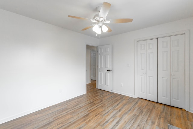 unfurnished bedroom with ceiling fan, light hardwood / wood-style floors, and a closet