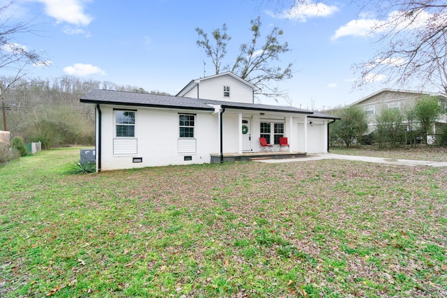 view of front of property with a garage, a front lawn, and a porch