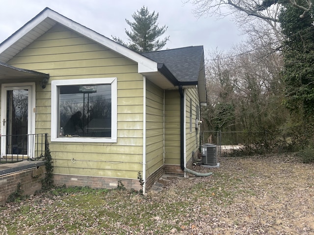 view of side of property featuring central AC unit