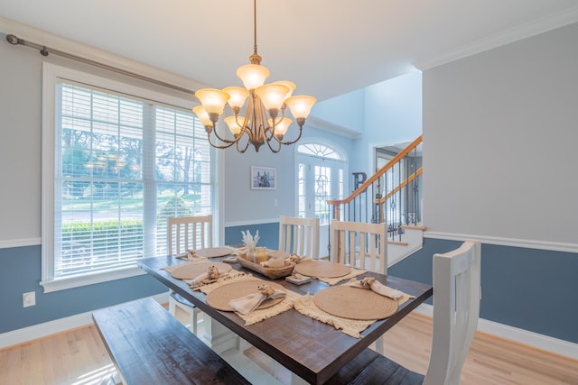 dining area with a healthy amount of sunlight, a notable chandelier, and light hardwood / wood-style floors