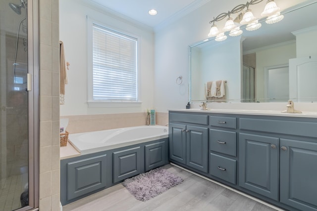 bathroom featuring vanity, hardwood / wood-style flooring, ornamental molding, and independent shower and bath