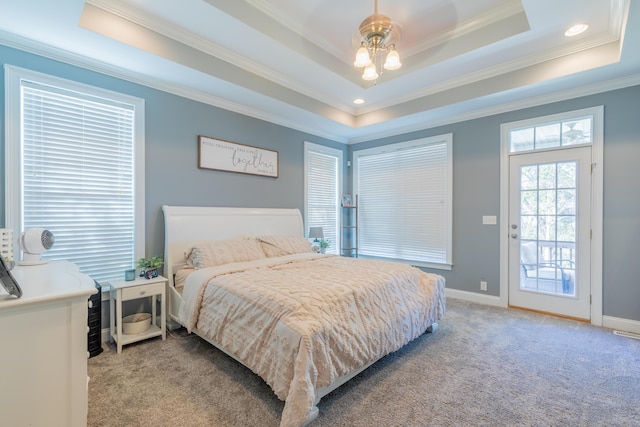 carpeted bedroom with a raised ceiling, crown molding, and access to exterior