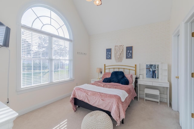 carpeted bedroom with lofted ceiling