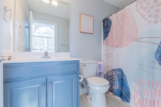 bathroom with tile patterned flooring, vanity, curtained shower, and toilet