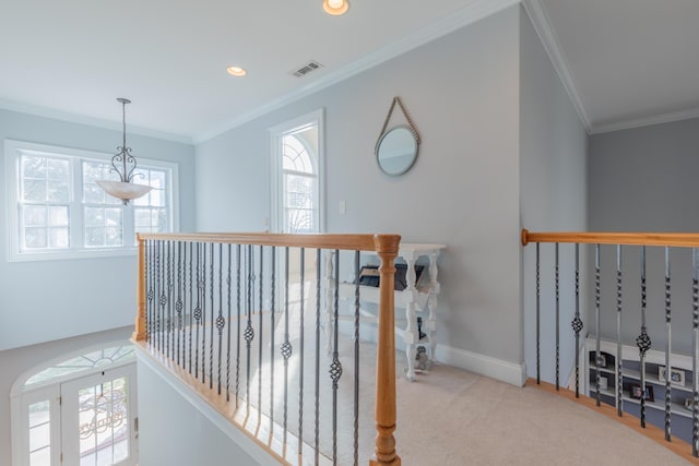 hall featuring ornamental molding and light colored carpet