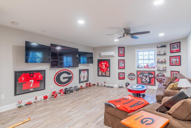 recreation room with ceiling fan, a wall mounted AC, and light hardwood / wood-style floors