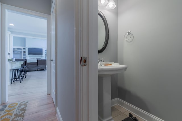 bathroom featuring wood-type flooring and sink