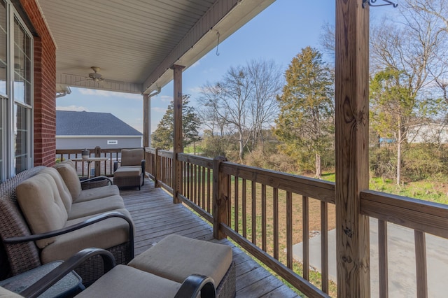 wooden terrace featuring ceiling fan