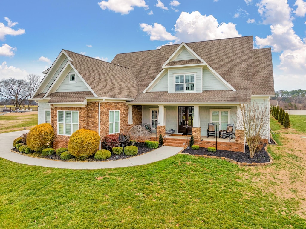 craftsman inspired home featuring a front yard and a porch