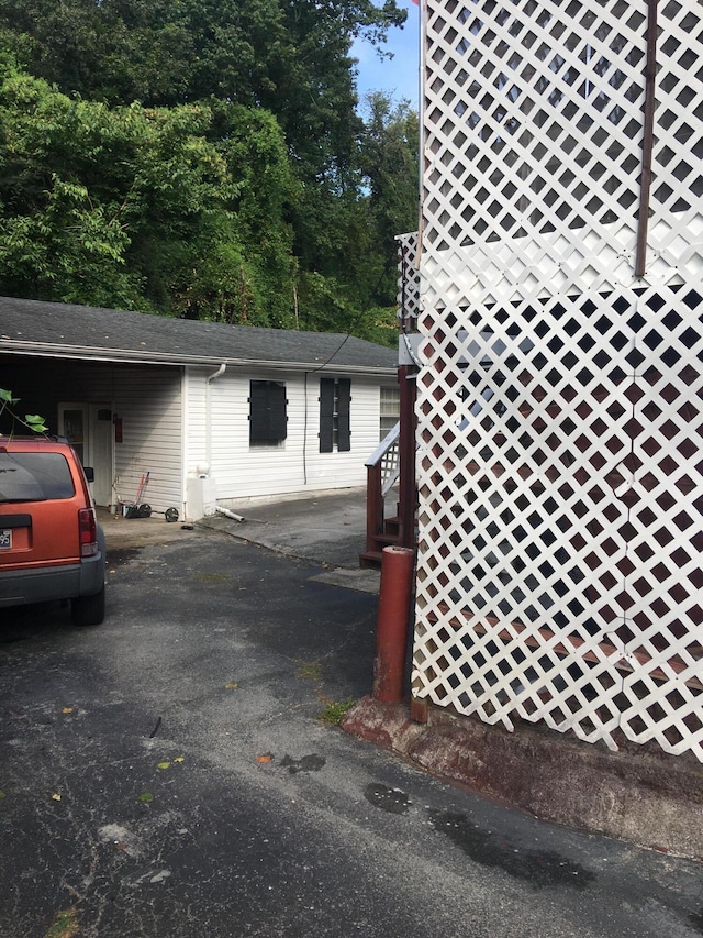 view of property exterior with a carport