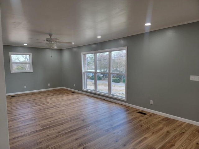 unfurnished room featuring visible vents, baseboards, ceiling fan, recessed lighting, and wood finished floors