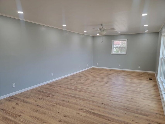 unfurnished room featuring light wood-type flooring, a ceiling fan, ornamental molding, recessed lighting, and baseboards
