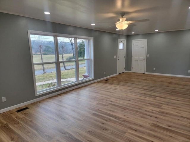 interior space with ceiling fan, visible vents, recessed lighting, wood finished floors, and baseboards