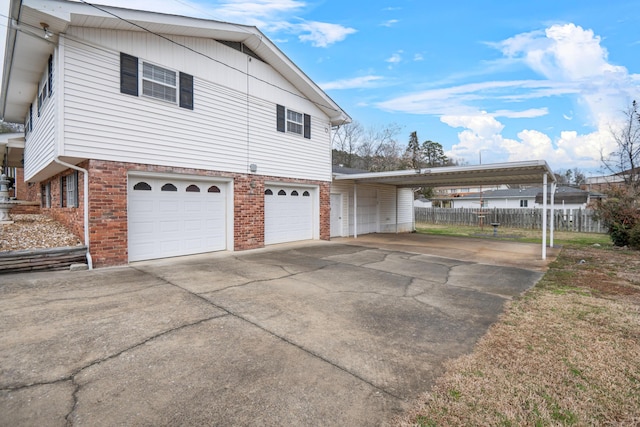 view of side of home with a garage and a carport