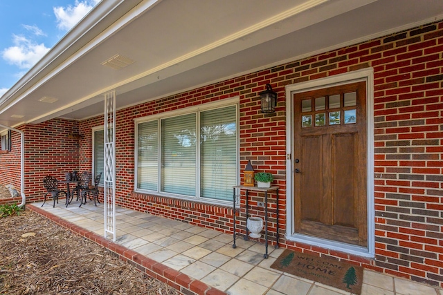 view of exterior entry with covered porch