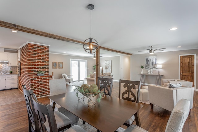 dining area featuring dark hardwood / wood-style floors, beam ceiling, and crown molding