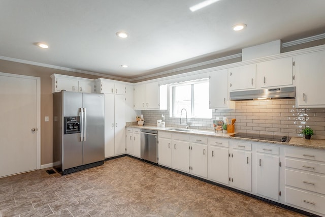 kitchen with stainless steel appliances, sink, white cabinets, and backsplash