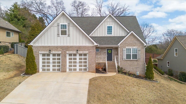 view of front of property with a garage, brick siding, a shingled roof, driveway, and board and batten siding