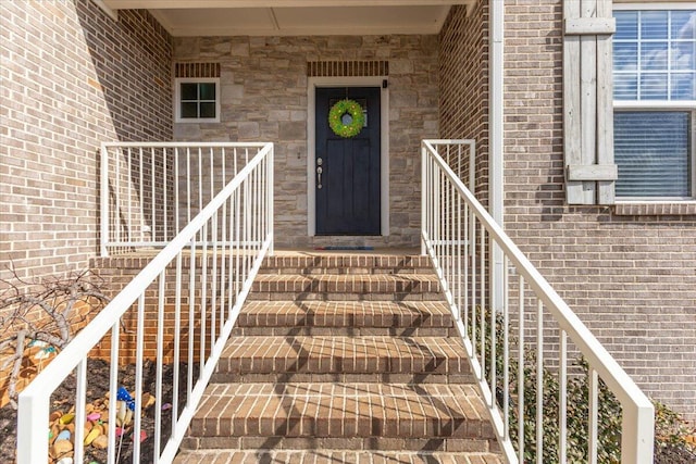 doorway to property with brick siding