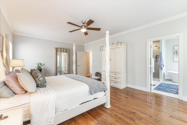 bedroom featuring crown molding, connected bathroom, ceiling fan, wood finished floors, and baseboards