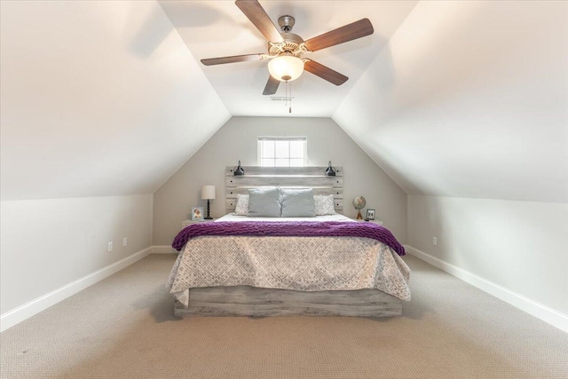 carpeted bedroom featuring ceiling fan, baseboards, and vaulted ceiling