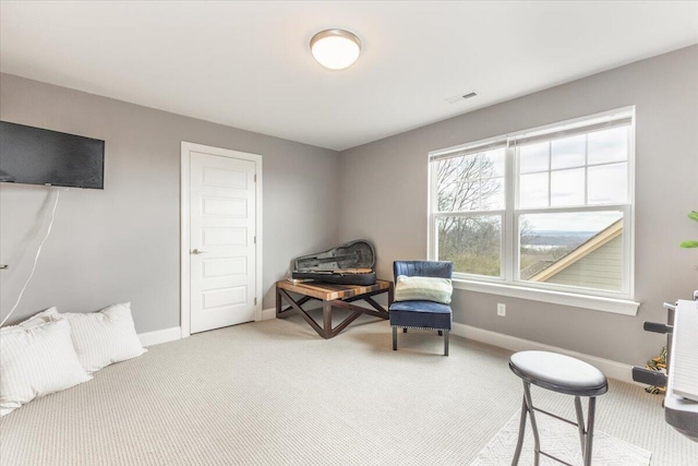 sitting room featuring carpet, visible vents, and baseboards