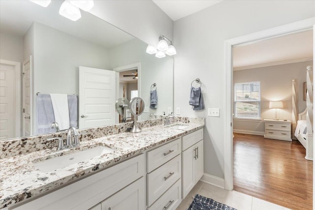 bathroom with tile patterned flooring, a sink, baseboards, and ceiling fan