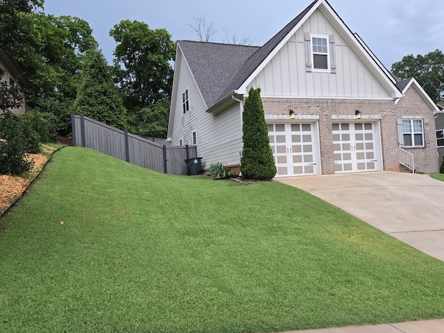 1609 Capanna Trl, Hixson, TN 37343 - view of home's exterior featuring board and batten siding, brick siding, concrete driveway, and roof with shingles