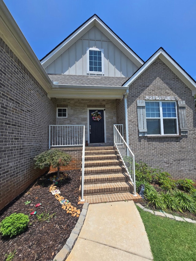 1609 Capanna Trl, Hixson, TN 37343 - property entrance featuring board and batten siding, brick siding, and covered porch
