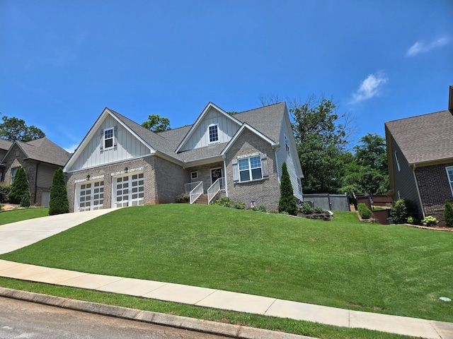 1609 Capanna Trl, Hixson, TN 37343 - craftsman-style home with board and batten siding, brick siding, a front yard, driveway, and an attached garage