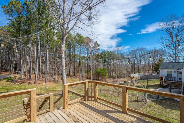 wooden deck with a lawn