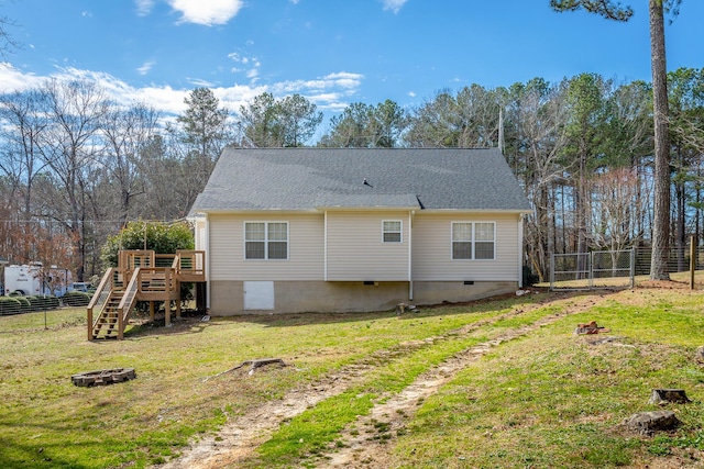 back of house featuring a lawn, crawl space, fence, a wooden deck, and stairs