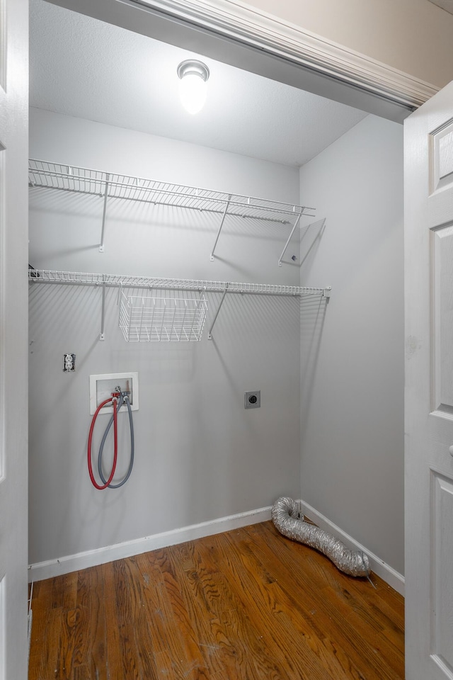 washroom featuring baseboards, laundry area, hookup for a washing machine, wood finished floors, and hookup for an electric dryer