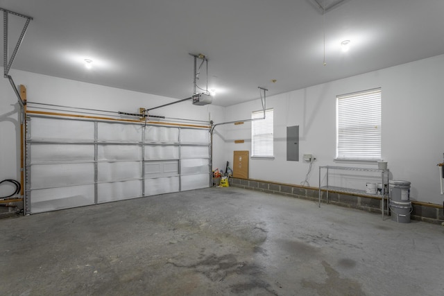 garage featuring electric panel and a garage door opener