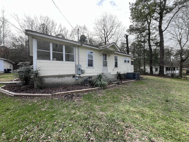 view of front of property featuring central AC and a front lawn