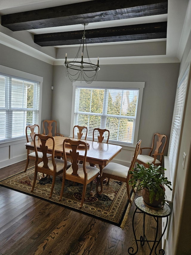 dining space with a notable chandelier, beam ceiling, and wood-type flooring