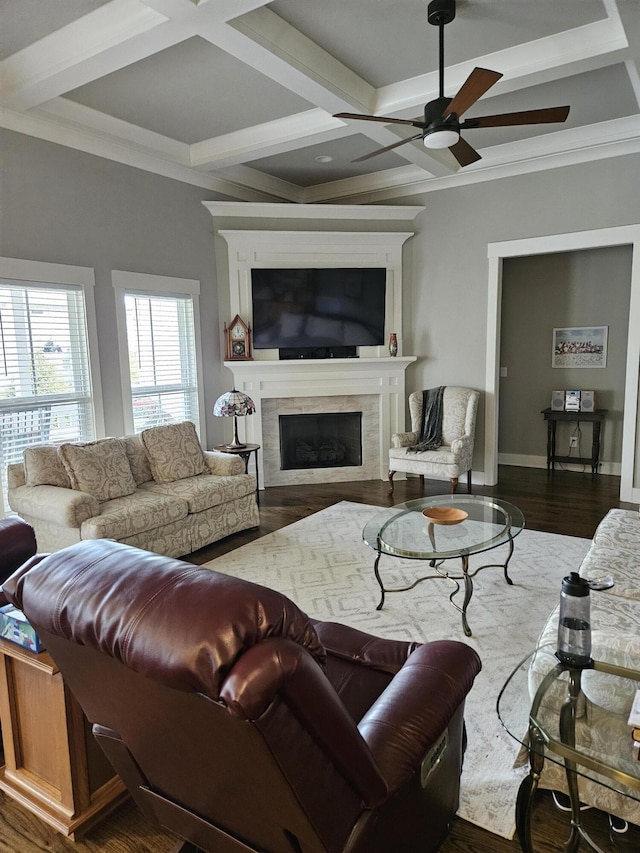 living room featuring coffered ceiling, wood-type flooring, beamed ceiling, crown molding, and ceiling fan