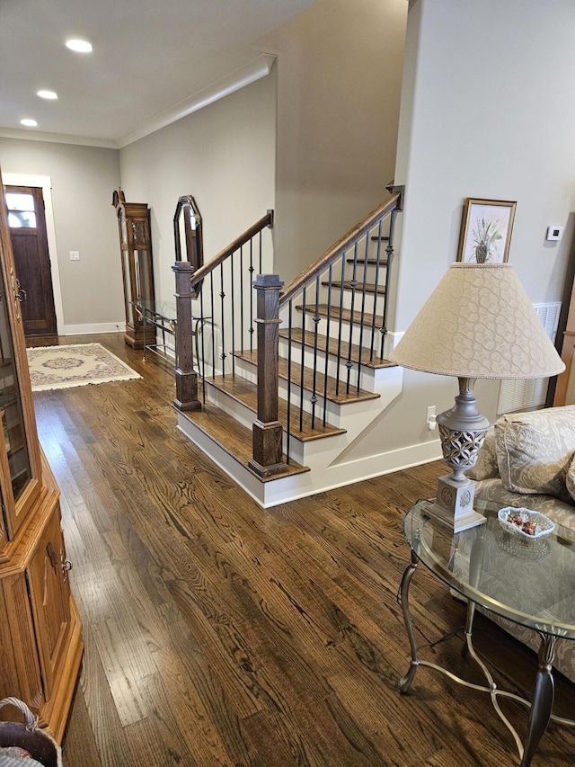 entryway with crown molding and dark hardwood / wood-style floors