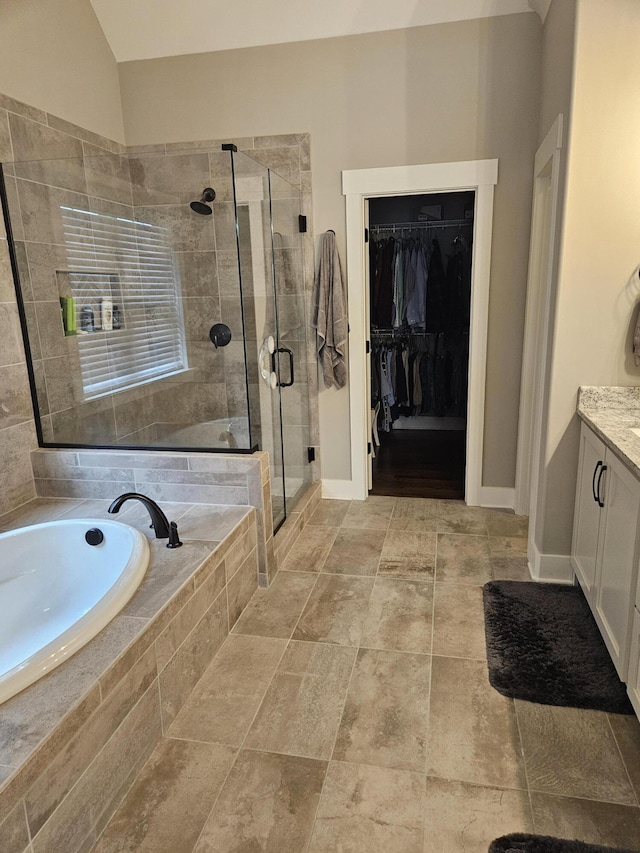 bathroom with separate shower and tub and vanity