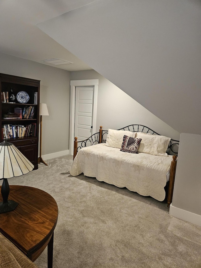 carpeted bedroom featuring vaulted ceiling