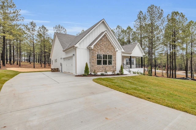 modern farmhouse style home with driveway, a porch, board and batten siding, a front yard, and a garage