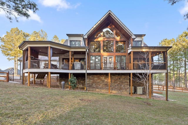 back of house featuring a yard and a sunroom