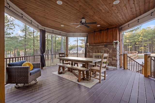 sunroom / solarium with wood ceiling and ceiling fan