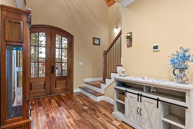 foyer with dark hardwood / wood-style floors and french doors