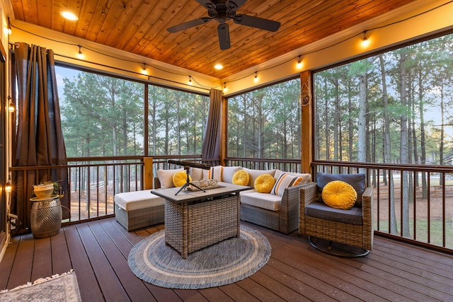 sunroom with ceiling fan, a healthy amount of sunlight, and wooden ceiling