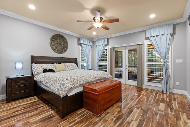 bedroom with access to exterior, wood-type flooring, ornamental molding, and french doors