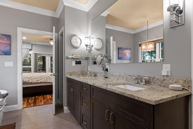 bathroom featuring tile patterned flooring, vanity, plenty of natural light, and ornamental molding